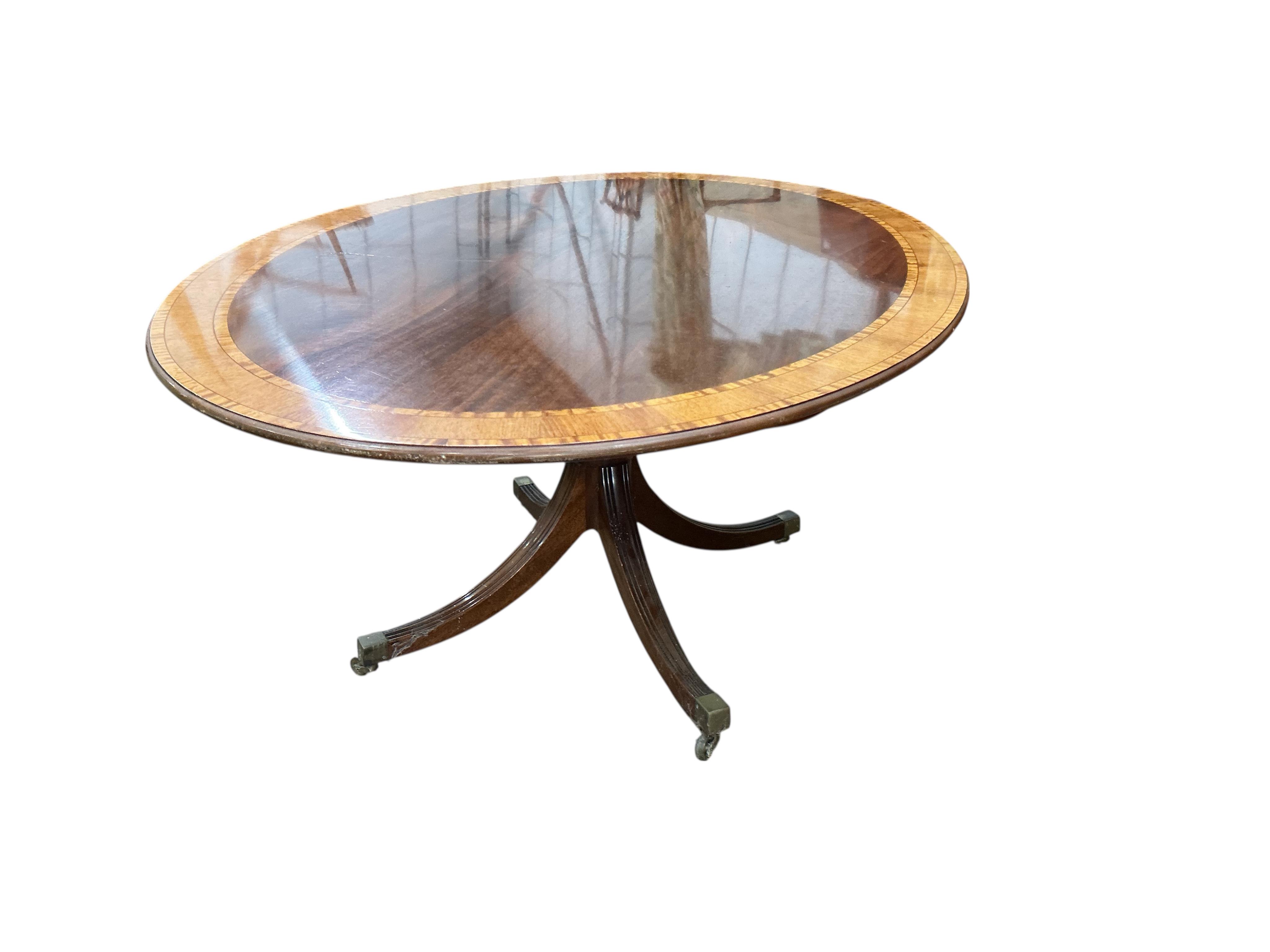 A reproduction William Tillman George III style oval banded mahogany dining table (lacks bolts), width 168cm, depth 120cm, height 72cm